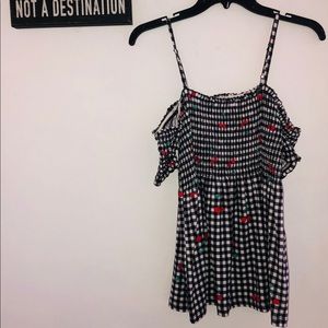 •Cherry on black and white blouse